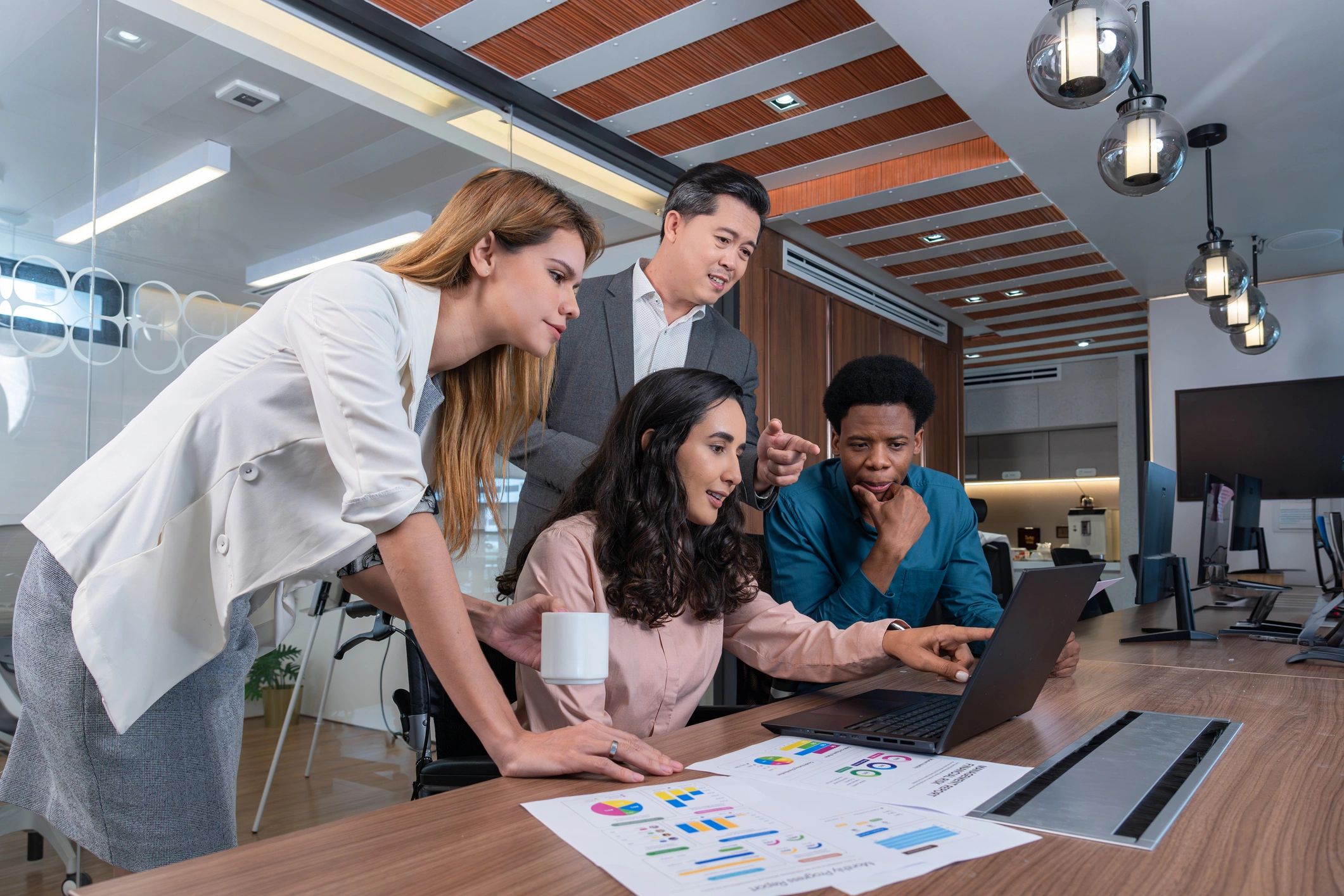 Colleagues collaborating around a table in a modern office